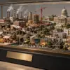 Un diorama economico di mercati, fabbriche e istituzioni sfugge a una teca con targa vuota