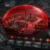Una città sotto una cupola rossa è osservata da griglie satellitari, tracciati e indizi luminosi: allegoria del mistero sulla cronologia di Wuhan